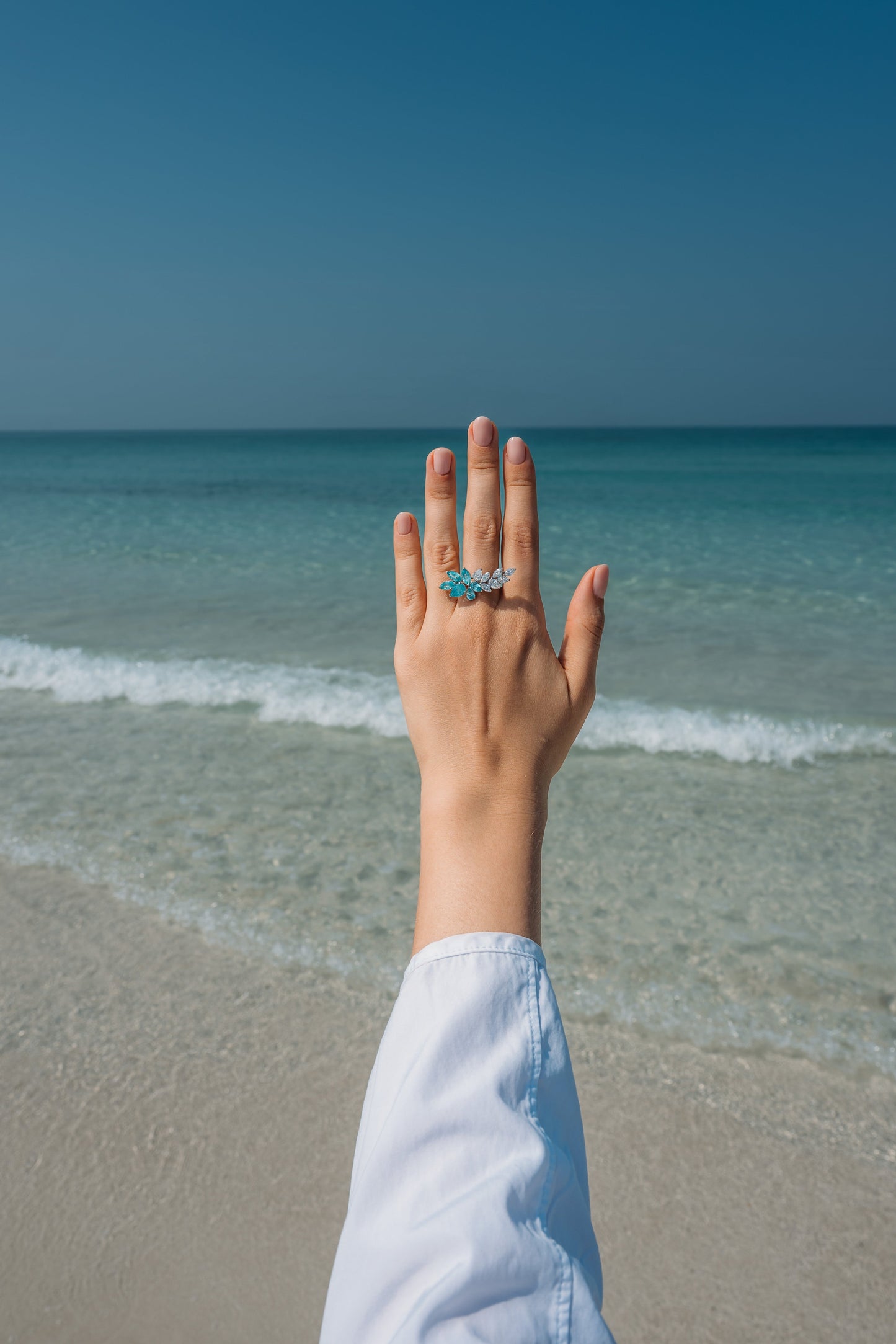 Verbesa Atelier lab-grown Paraiba sapphire branch cocktail ring worn on the hand at the beach