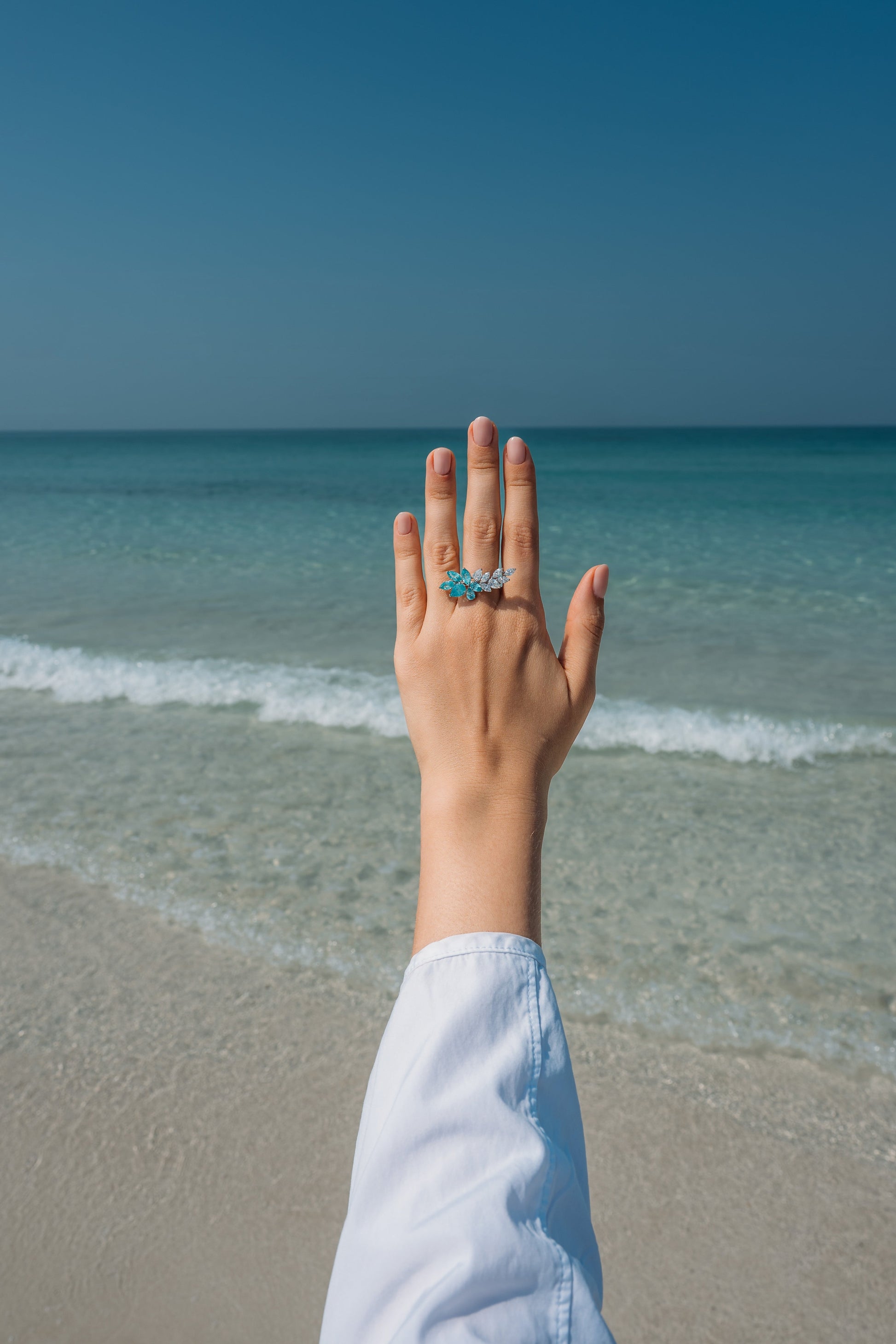 Verbesa Atelier lab-grown Paraiba sapphire branch cocktail ring worn on the hand at the beach