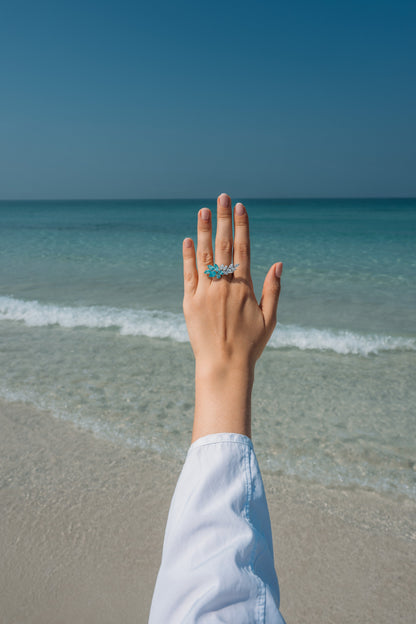 Verbesa Atelier lab-grown Paraiba sapphire branch cocktail ring worn on the hand at the beach