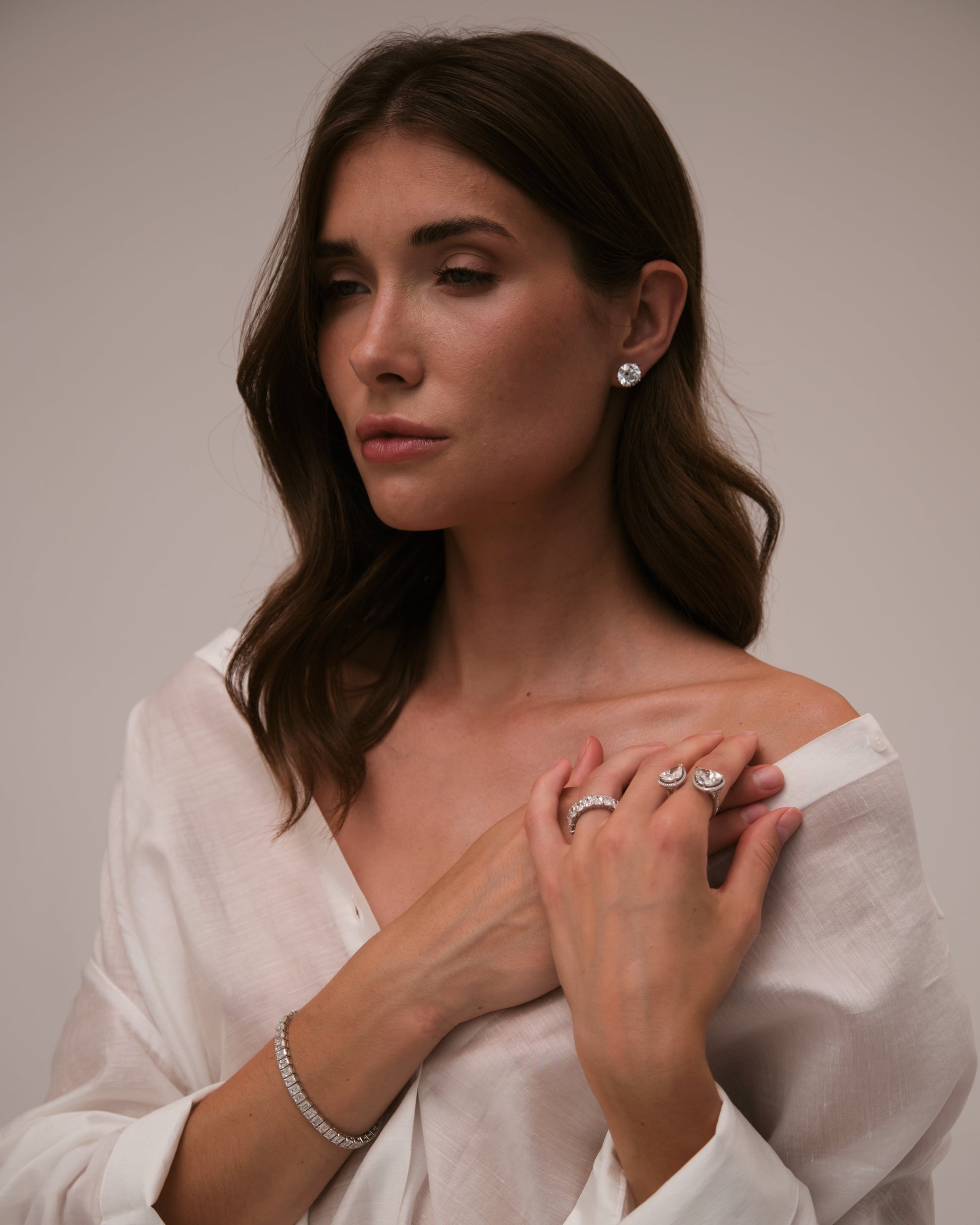 Model wearing Verbesa Atelier round-cut lab-grown diamond stud earrings in an editorial portrait