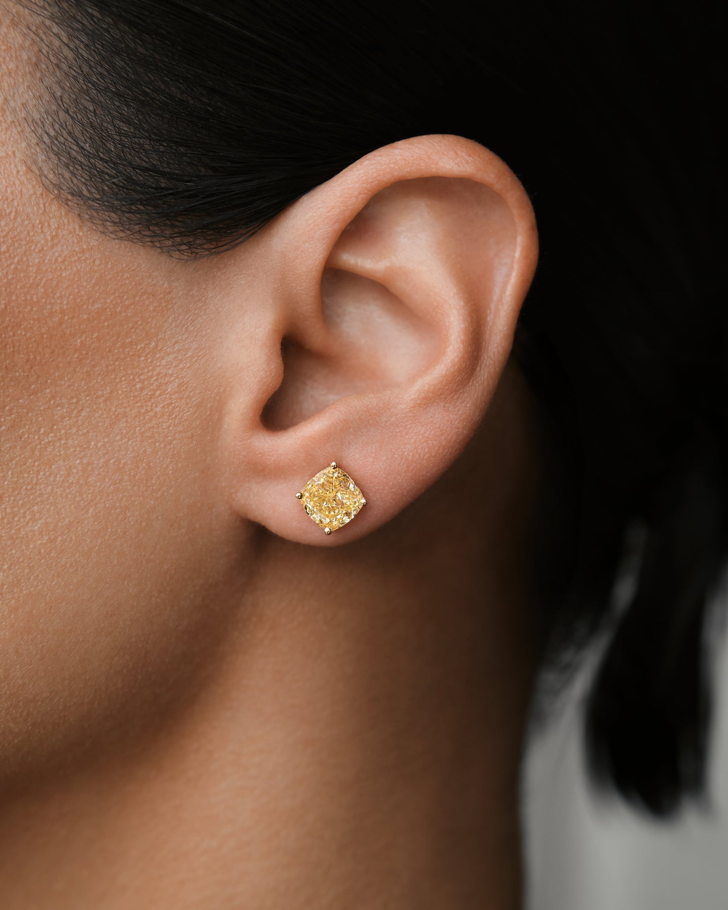 Verbesa Atelier yellow cushion-cut lab-grown diamond stud earring worn close up