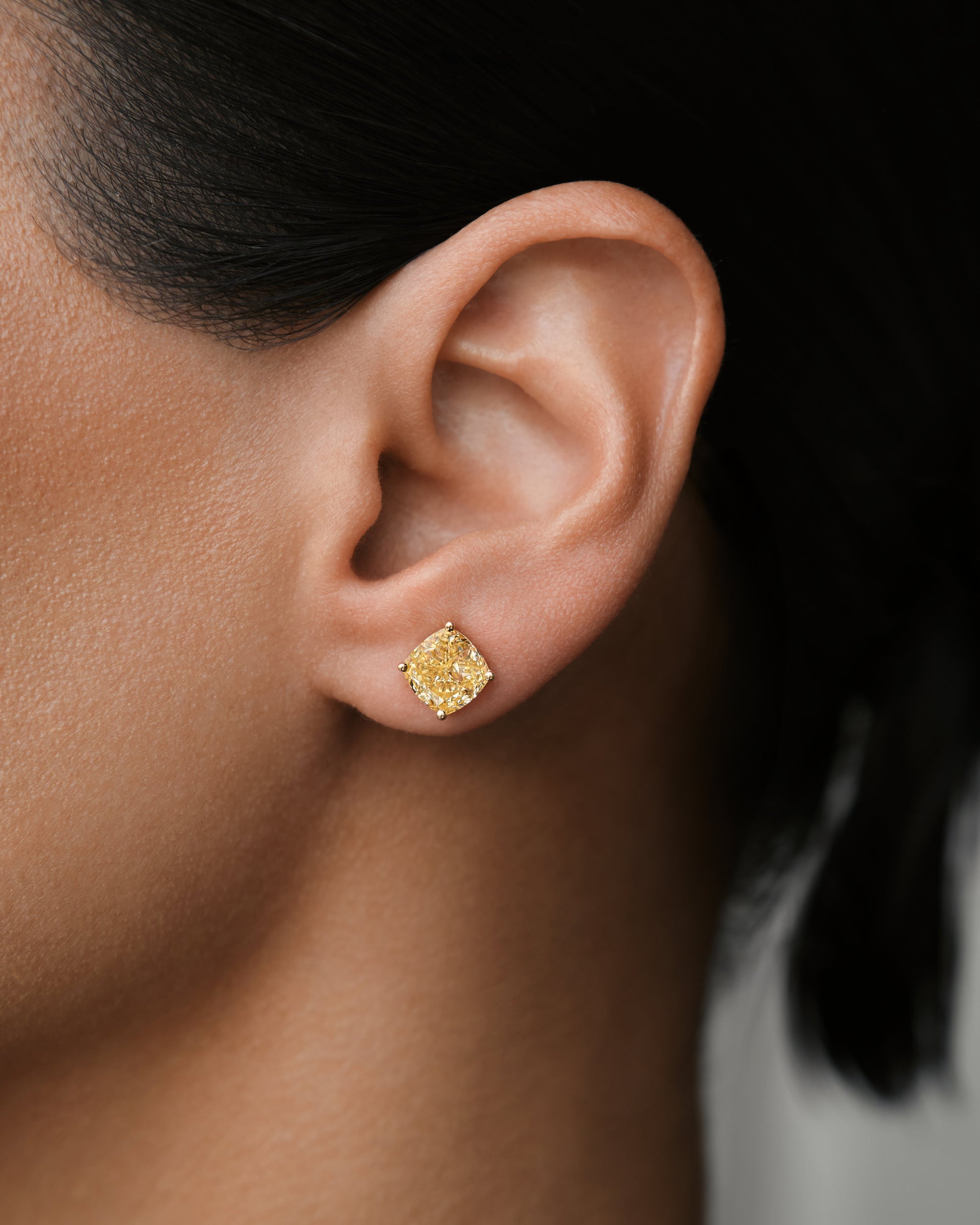 Verbesa Atelier yellow cushion-cut lab-grown diamond stud earring worn close up