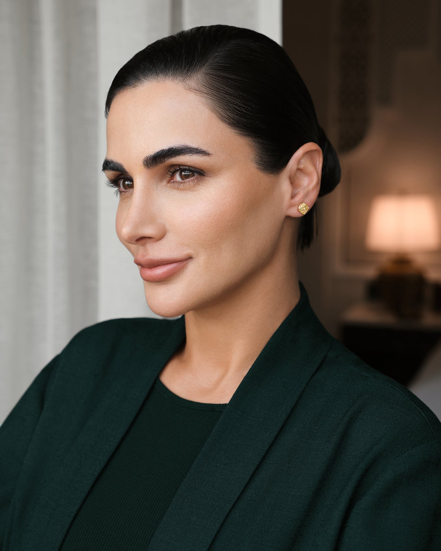 Model wearing Verbesa Atelier yellow cushion-cut lab-grown diamond stud earrings