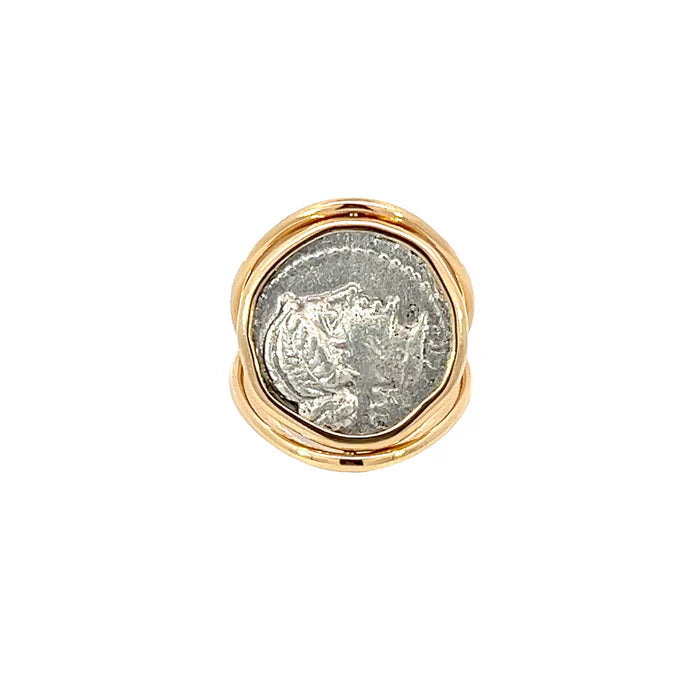 Gold ring with a silver coin embedded in the center on a white background