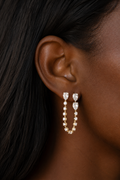 White Drop Pear Chain Earring in yellow gold worn in an original model image