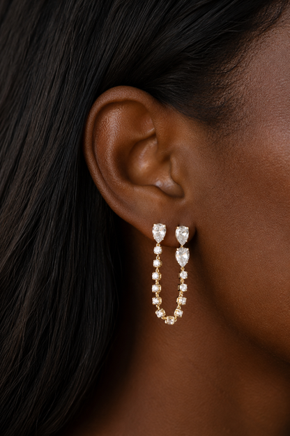 White Drop Pear Chain Earring in yellow gold worn in an original model image