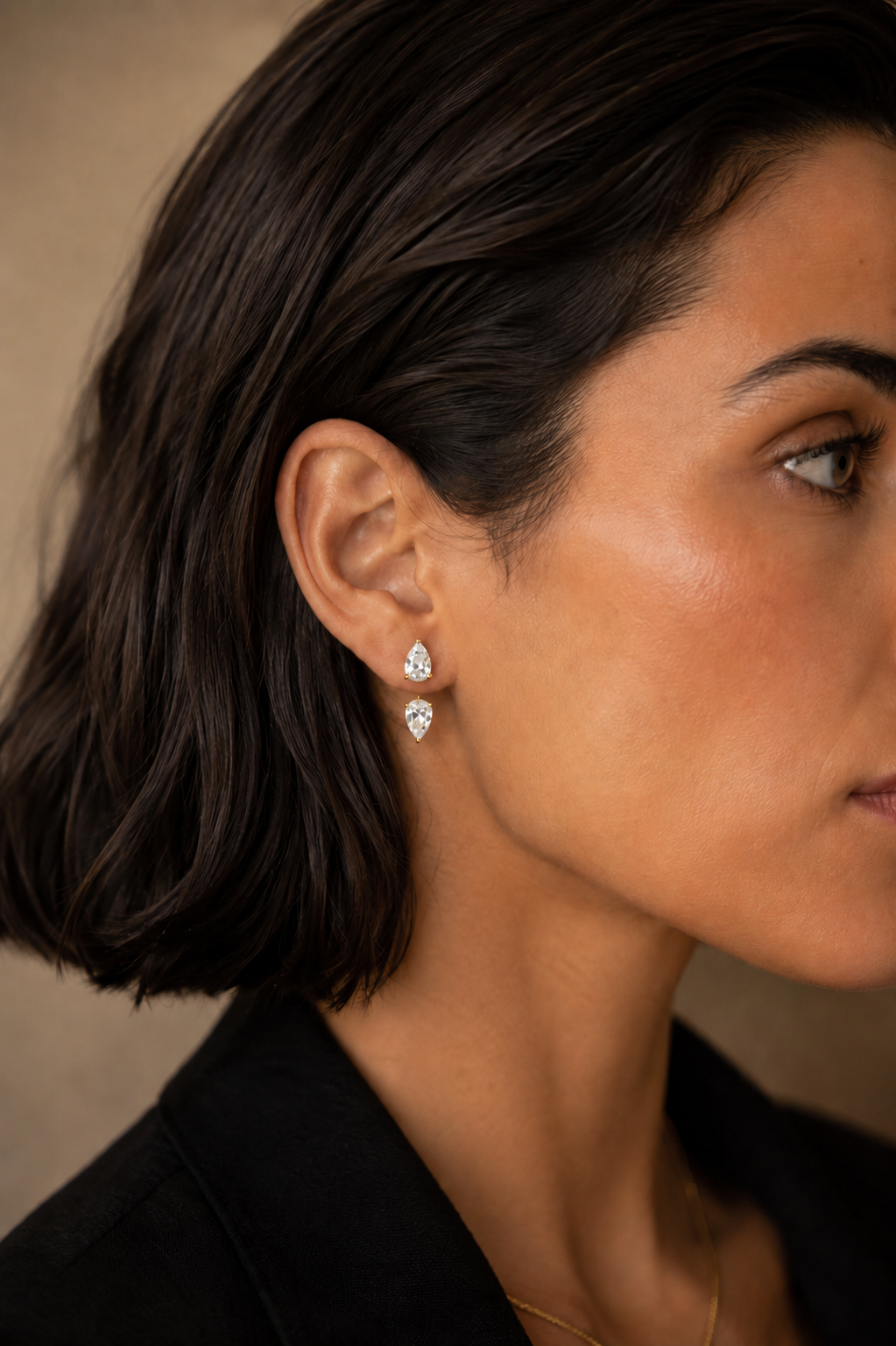 White Drop Pear Diamond Studs with Ear Jackets in yellow gold worn in an original model image