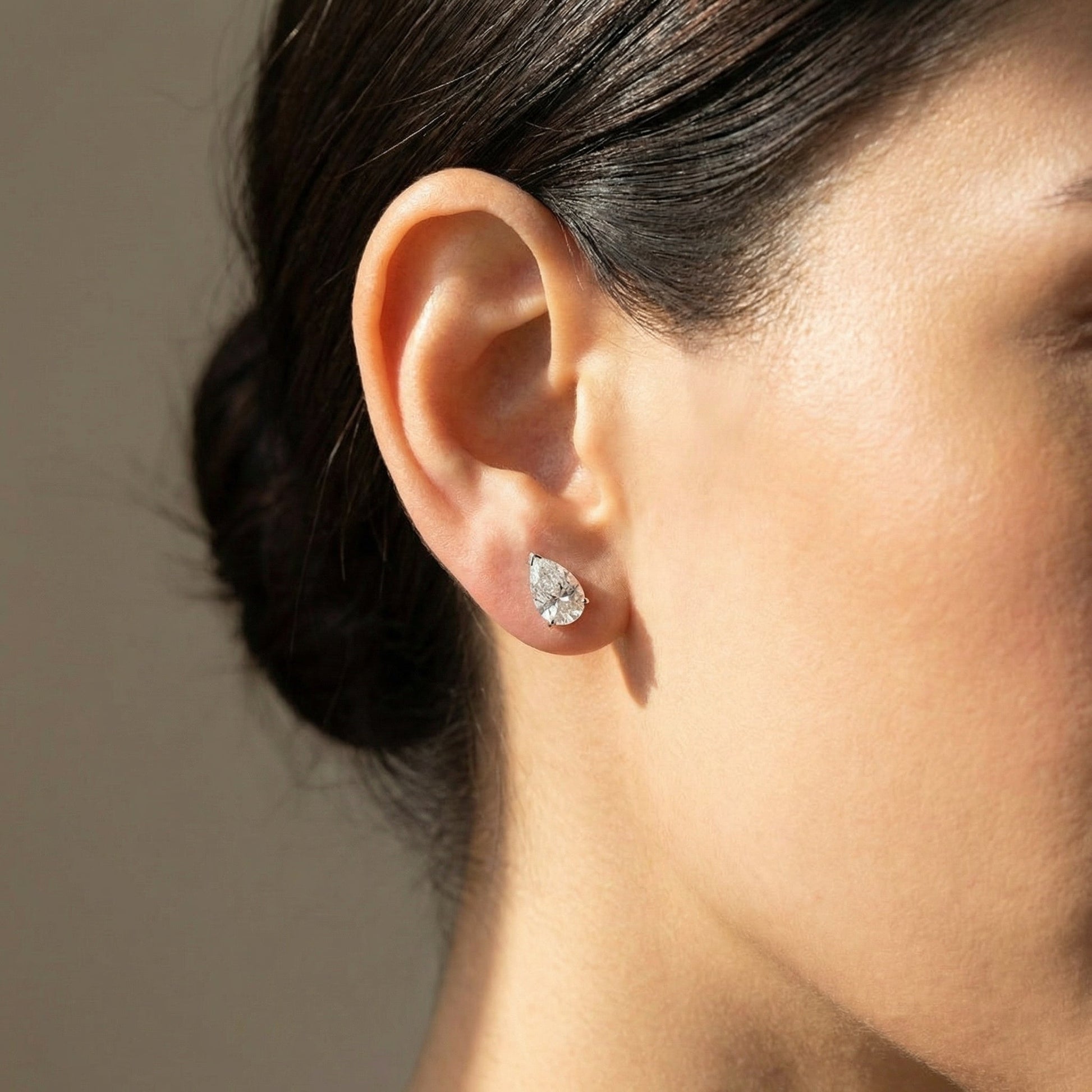 White Drop pear diamond studs worn in the original lifestyle image