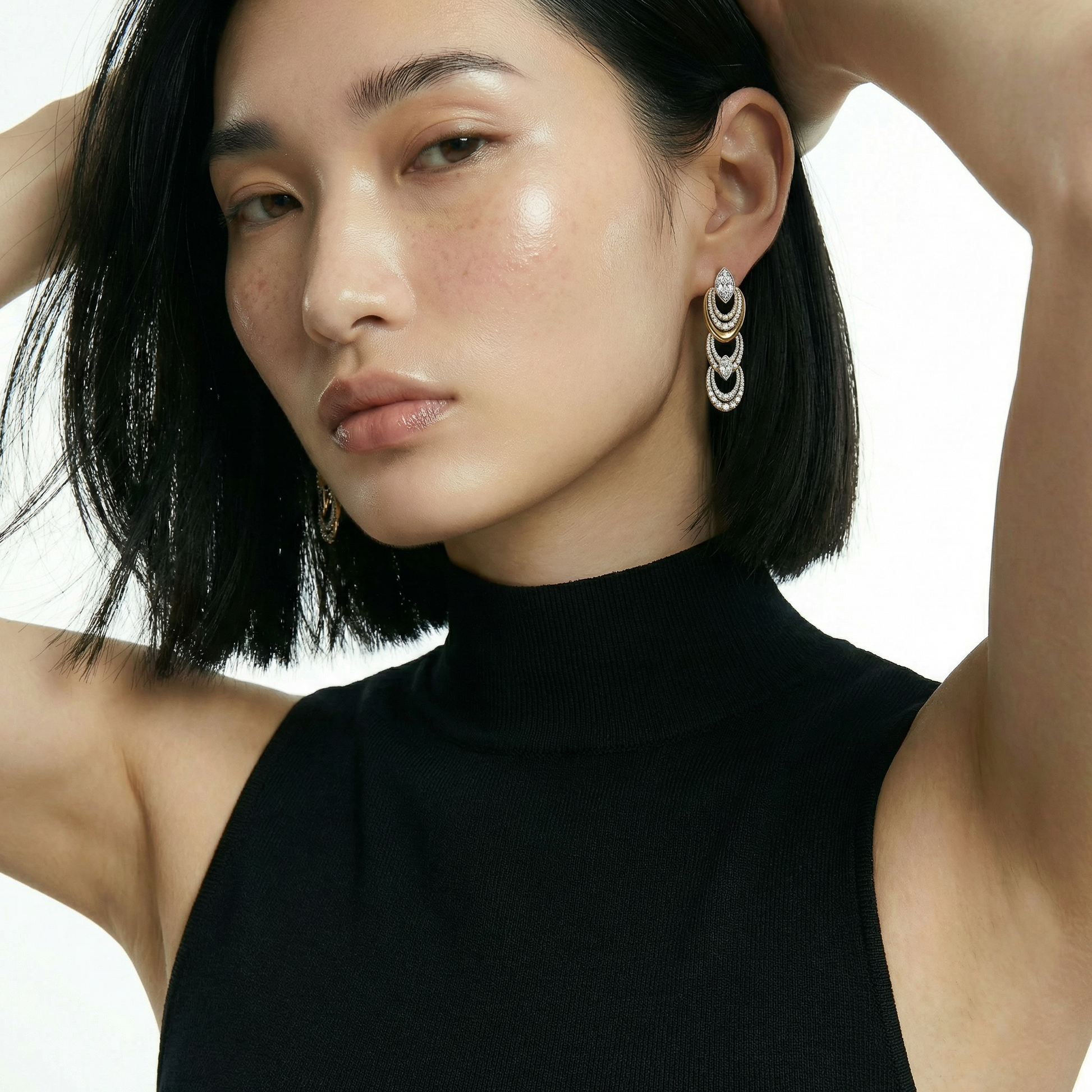 ZORÁE Unbound Eclipse 18K yellow gold earrings worn on model